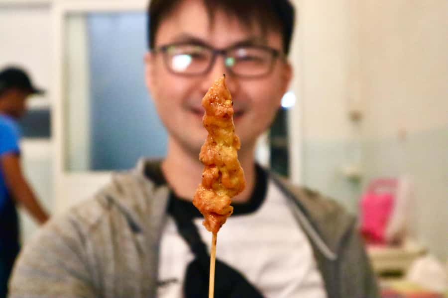 Bangkok: Chinatown Street Food Tour with 8+ Local Dishes - Starting under the orange umbrella at Hua Lamphong