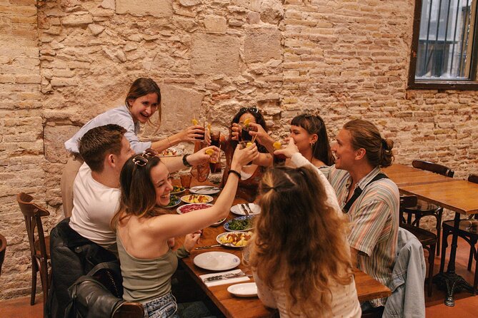 Barcelona: Guided Food Walking Tour with Tapas and Wine - The old bodega, the porrón, and Catalan sausage