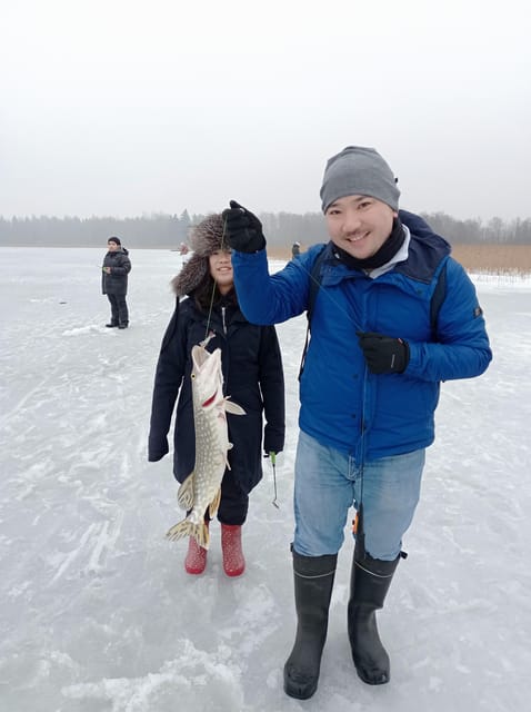 From Helsinki: Bodom Lake Ice Fishing with Food & Drinks - Learning to drill through the ice