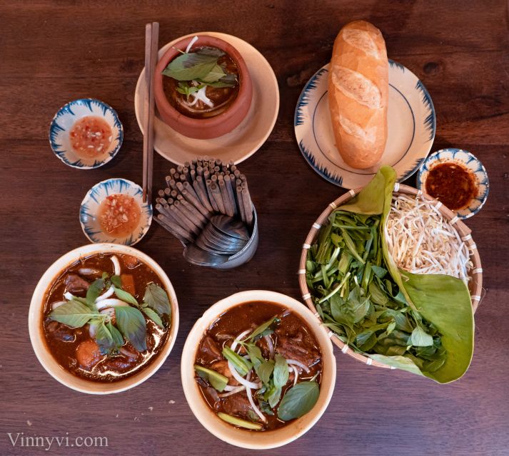 Ho Chi Minh City: Private Street Food Motorbike Tour - Old apartments and a pagoda above the street