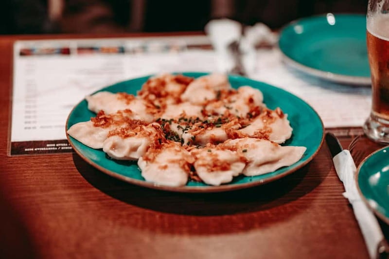 Krakow: Tipsy Polish Food Tour With History, Pierogi & Shots - The Polish tasting plate: herring, pickles, smalec, and bigos