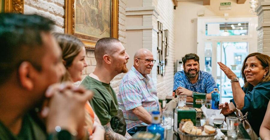 Madrid: Food & Wine Tour with 10 Tapas & 4 Drinks Included - The neighborhood bar: Madrid without the postcard setting