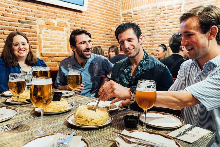 Madrid Guided Food Tour with Tapas and Spanish Wine - What solo visitors, couples, and families should expect