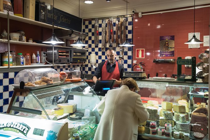 Madrid Tapas & Wine Tasting Walking Tour – Small Group Local Bars - Stop two: a wine shop behind the bottles