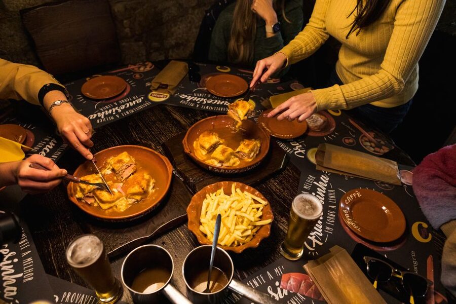 Porto: Food & Wine Tasting Walking Tour with Port Wine Cave - Follow the Port story into an old cellar