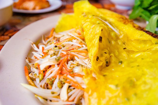 Private Vegan Food Tour By Scooter in Ho Chi Minh City - Meeting your guide and entering the traffic