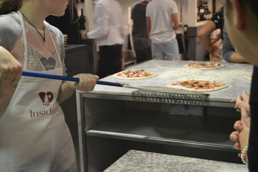Rome: Hands-On Pizza Making Class near the Vatican with Wine - Putting Your Pizza in the Oven