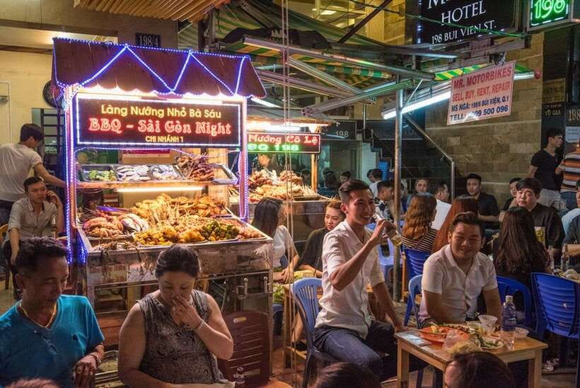 Saigon at Sunset: Ultimate Street Food Experience - Grilled beef, street beer, and low plastic chairs